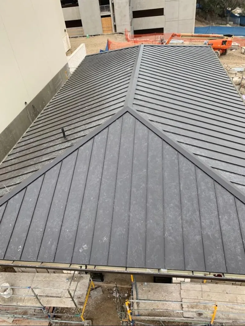 Commercial metal roof construction with crane equipment in Haverford