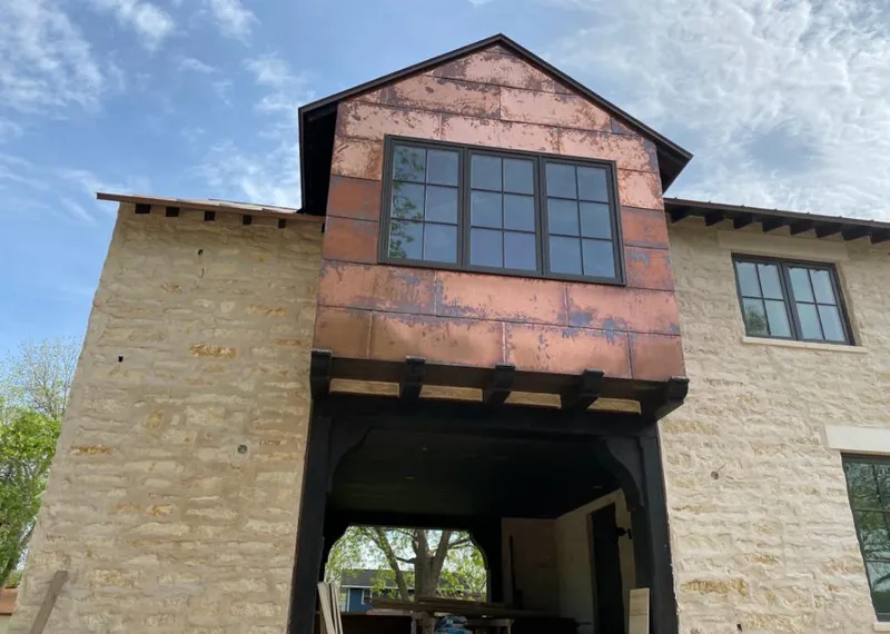 Copper metal panel facade on a stone building for Skylight Installation in Haverford